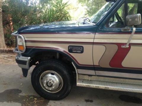 1986 Ford Bronco - This Ford F-350 truck features a two-tone paint scheme with distinctive stripe graphics on the side.