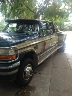1986 Ford Bronco - This crew cab dually truck features a visor and a two-tone paint scheme of dark green and tan.