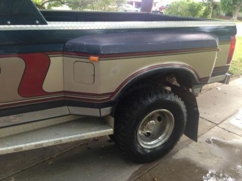 1986 Ford Bronco - This is a side view of a Ford F-Series truck, likely from the early 1980s, dual rear wheels and distinctive body graphics.