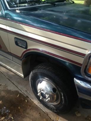 1986 Ford Bronco - The F350 badge is visible on the side of this two-tone truck, which features dual rear wheels.