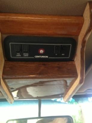 1986 Ford Bronco - Close-up of an interior control panel with various light switches and an auxiliary power switch.