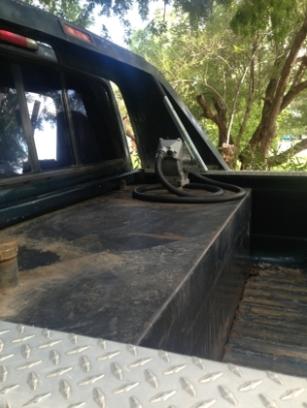 1986 Ford Bronco - Auxiliary fuel tank installed in the bed of a truck, seen from the rear passenger side.