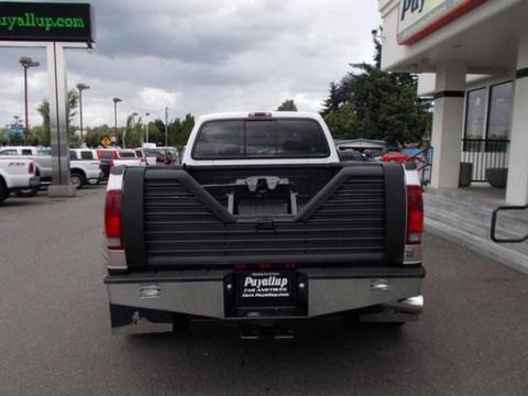 2001 Ford F-350 - Rear view of a 2001 Ford F-350 pickup truck parked in a lot with other vehicles.