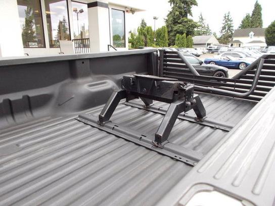Truck bed with fifth wheel hitch and "SUPERMOTORS" logo