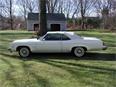 1975 Oldsmobile Delta 88 - Side view of a white 1975 Oldsmobile Delta 88 coupe on a sunny day.