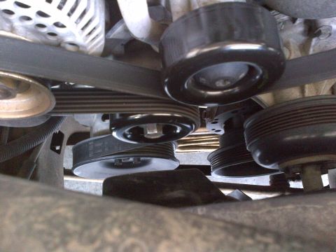 1994 Ford Bronco - Close-up view of the engine's serpentine belt and pulley system.