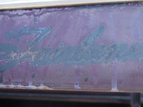 1969 Ford Fairlane - Close-up of weathered script lettering on a vehicle's body panel.