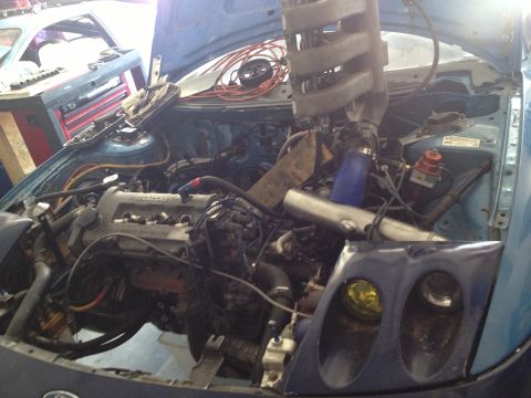 1995 Ford Probe - Customized engine bay with visible turbo piping and intake manifold.