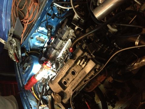 1995 Ford Probe - The engine bay of a vehicle, showing a Mazda V6 engine with visible wiring and plumbing.