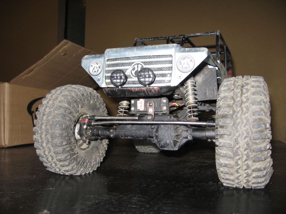 Front axle, suspension, and large tires of a remote control rock crawler