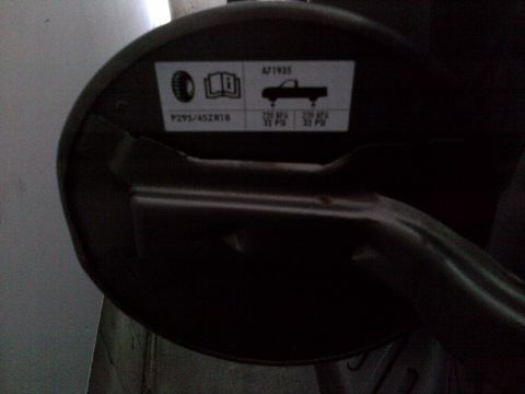 2003 Ford F-150 - Sticker on a vehicle part shows tire size and recommended inflation pressures.