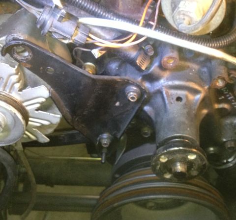 1978 Ford Bronco - Close-up view of engine components, including a black metal bracket and pulleys.