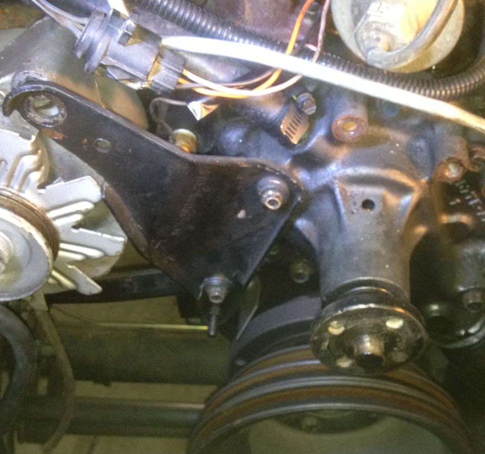 Engine bracket and pulleys on a black engine block
