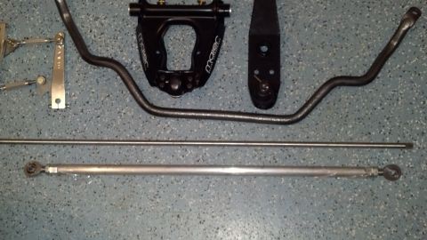 1970 Ford Torino - Various automotive suspension components are laid out on a speckled floor, suggesting a custom build or repair.