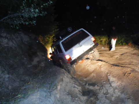 2005 Jeep Wrangler - Jeep Cherokee navigates a challenging off-road trail in the dark.