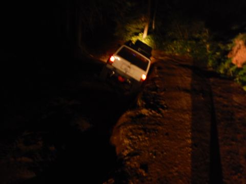 2005 Jeep Wrangler - A white 2005 Jeep Wrangler is seen on a dirt road at night.