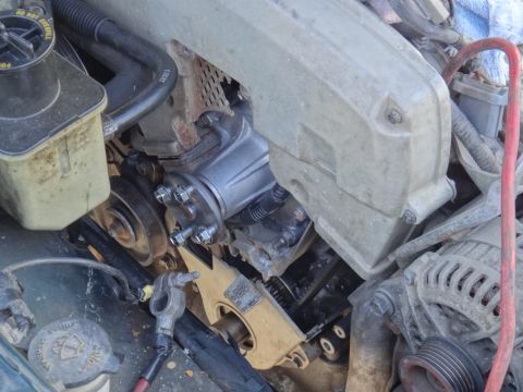 1995 Ford Taurus - Close-up view of engine components, including the power steering pump and alternator.