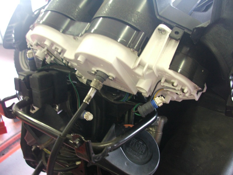 Close-up of motorcycle instrument cluster wiring and components