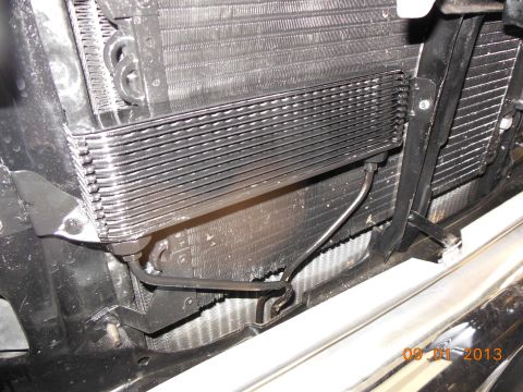 1979 Ford F-150 - Close-up view of a transmission cooler, likely an OE Ford part, showing its finned construction and plumbing.