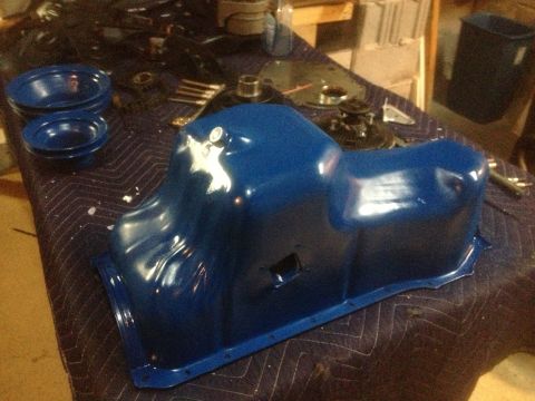 1978 Ford Bronco - A blue oil pan sits on a table, possibly awaiting installation or after being refurbished.