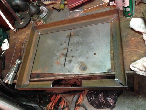 2004 Ford Crown Victoria - Metal fabrication project underway on a cluttered workbench with various tools and materials.