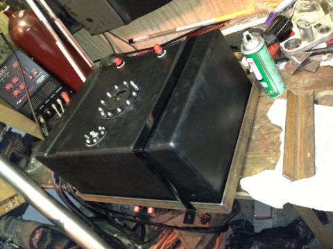 2004 Ford Crown Victoria - A custom fuel tank with a sump and dual fill necks sits on a workbench next to a welding machine.