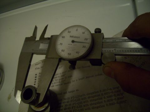 1995 Ford Probe - A dial caliper is used to measure a small metal component, with a Mitutoyo dial indicator showing precise measurements.