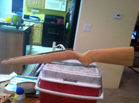 1989 Ford Bronco - A wooden gun stock is placed on top of a cooler in a kitchen setting.
