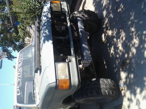 1986 Ford Bronco - This truck appears to be modified for off-road use, with its hood up and large tires visible.