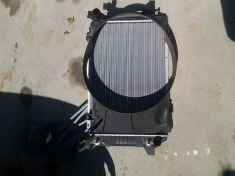 1986 Ford Bronco - Radiator and fan assembly shown from the front, resting on a concrete surface.