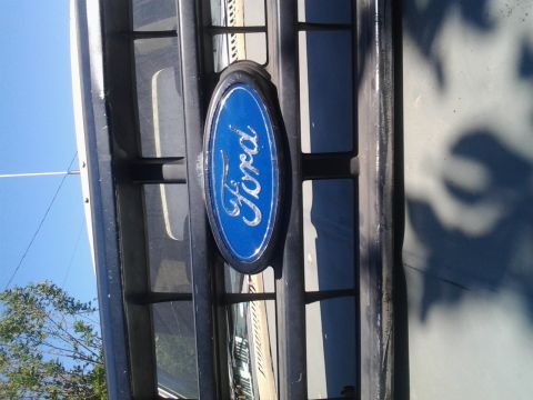 1986 Ford Bronco - Front grille detail the iconic blue Ford oval emblem.