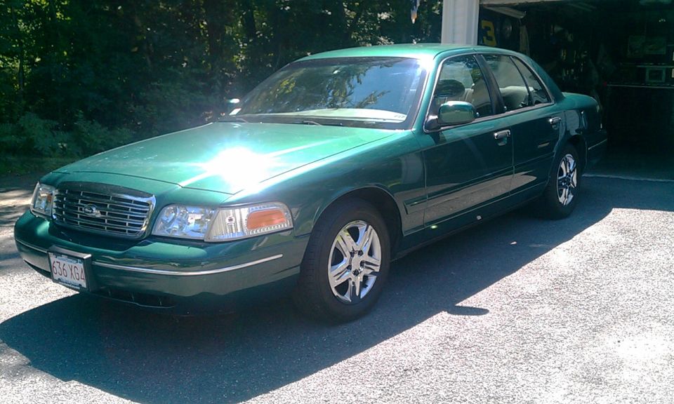 Green 2001 Ford Crown Victoria parked in driveway
