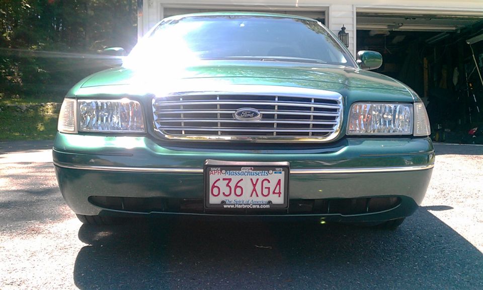 Green 2001 Ford Crown Victoria front view with chrome grille and Massachusetts license plate