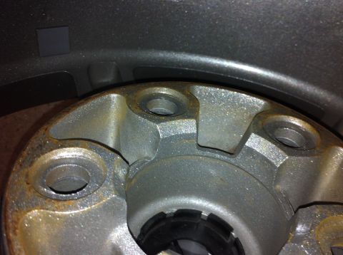 1995 Ford Mustang - Close-up view of a wheel hub, showing the lug nut holes and some surface rust. The registry claims this is a 1995 Ford Mustang, but the ima…