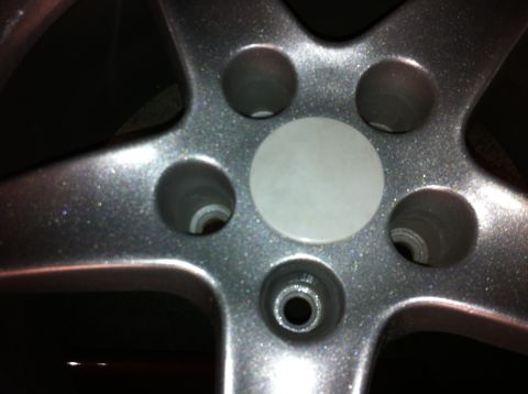 1995 Ford Mustang - Close-up of a silver alloy wheel's center cap area, showing the lug nut holes.