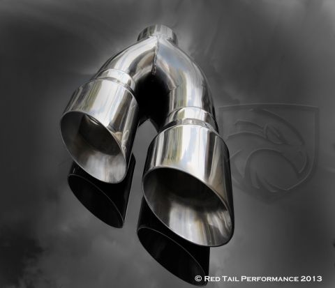 1982 Ford Bronco - A polished chrome dual exhaust tip assembly is shown against a dark, smoky background with a faint emblem.