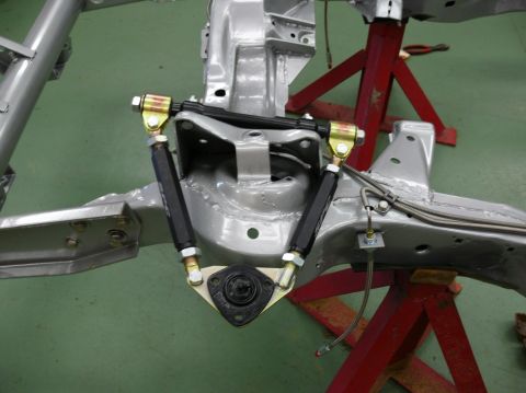 1976 Chevrolet Corvette - The front suspension of a C3 Corvette is shown, mounted on red jack stands.