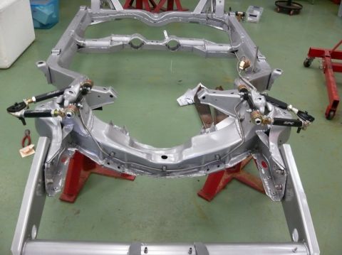 1976 Chevrolet Corvette - The chassis of a 1976 Chevrolet Corvette is shown in a workshop setting.