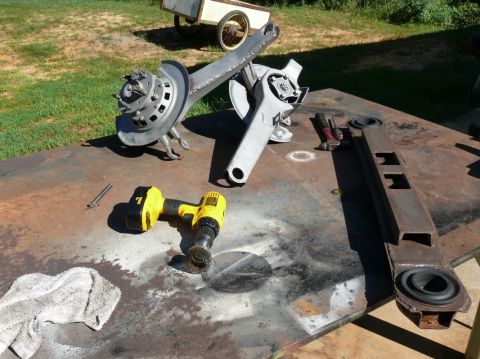 1976 Chevrolet Corvette - Car suspension parts are laid out on a workbench, ready for restoration or repair.