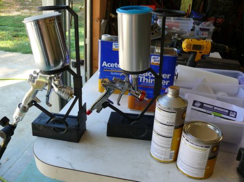 1976 Chevrolet Corvette - Two spray guns are set up with paint cans and solvents, suggesting a painting project.
