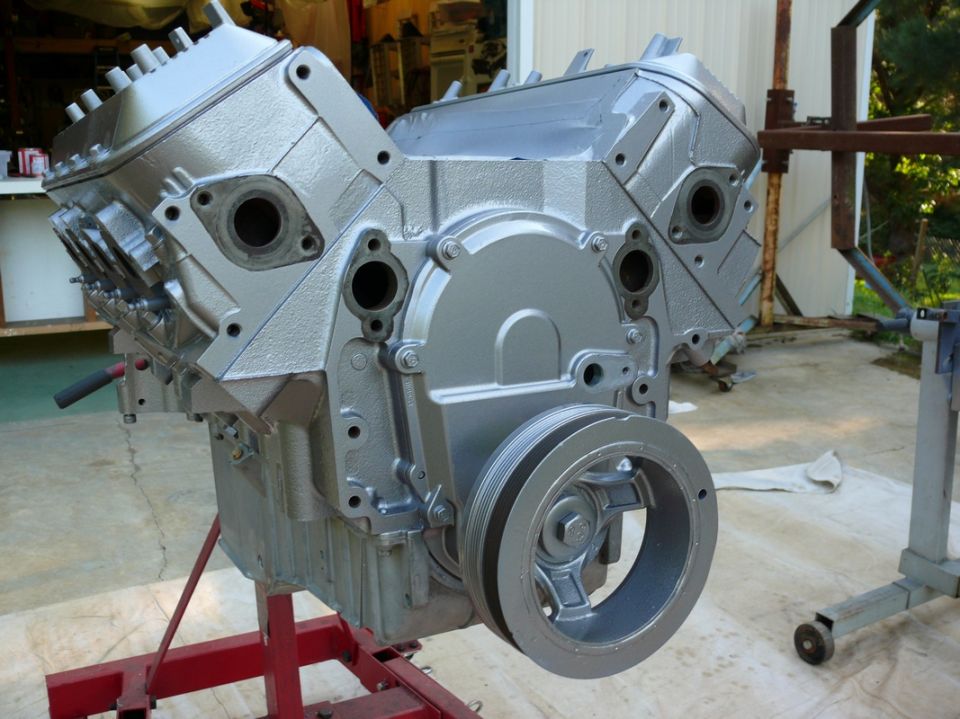 Silver engine block with pulley on stand