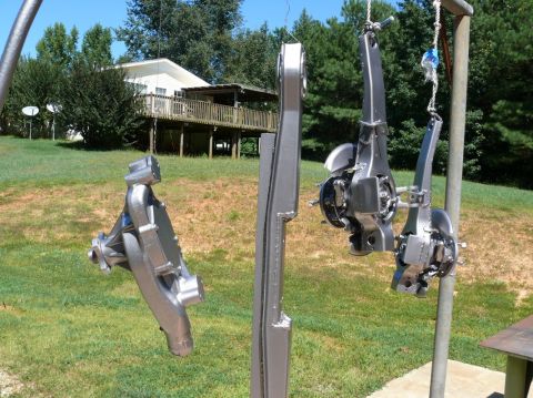 1976 Chevrolet Corvette - Car suspension parts hang in the air, ready for a new coat of paint.