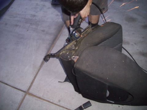 1995 Ford Probe - Cutting a car seat frame with an angle grinder. Sparks are visible.
