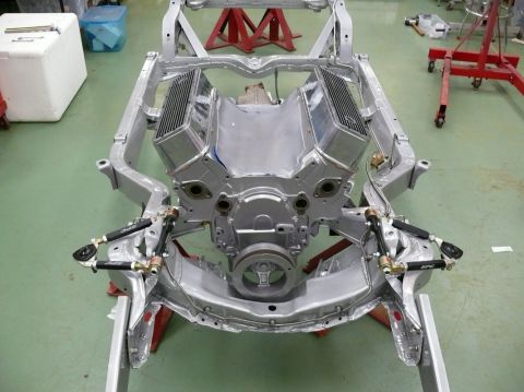 1976 Chevrolet Corvette - The chassis and engine of a car are shown, possibly undergoing restoration or modification.