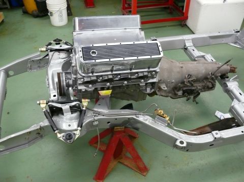 1976 Chevrolet Corvette - A disassembled vehicle's engine and chassis are shown, awaiting reassembly.