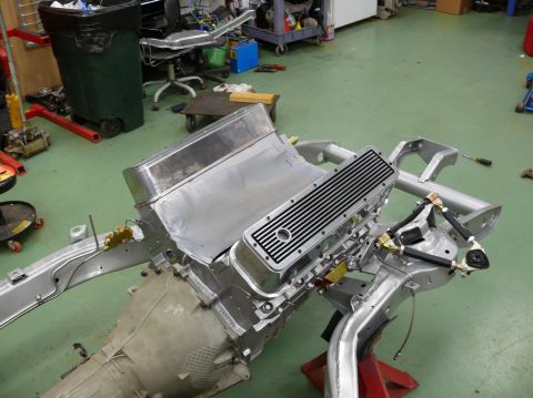 1976 Chevrolet Corvette - Chevrolet V8 engine and chassis components are laid out in a workshop setting.