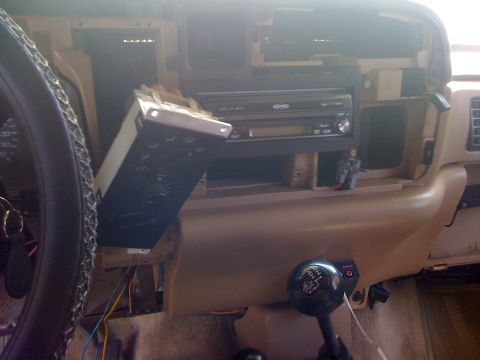 1997 Dodge 3500 - The dashboard of a vehicle is partially disassembled, revealing wiring and a car stereo unit.