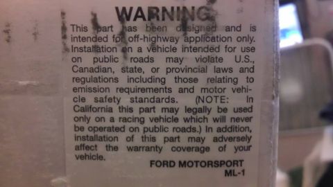 2000 Mercury Grand Marquis - A warning label details restrictions for a Ford Motorsport part, indicating it's for off-highway use only.