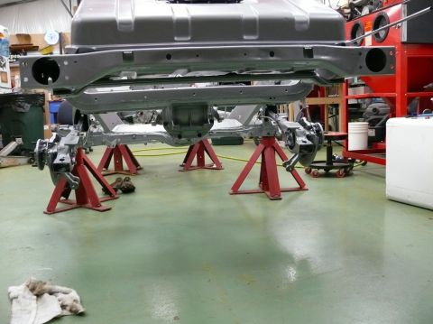 1976 Chevrolet Corvette - The underside of a vehicle chassis is elevated on jack stands for maintenance or repair.