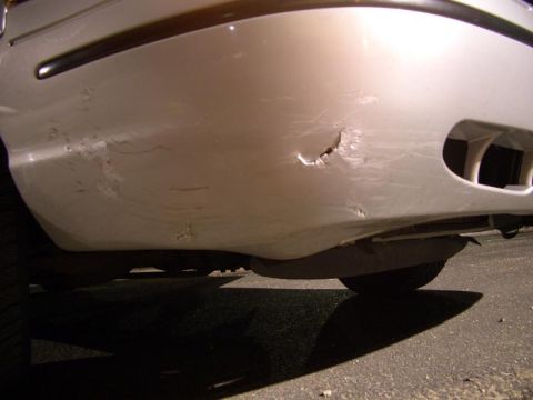 1999 Ford Crown Victoria - Some gouges in the front bumper, this is the only really noticable body damage on the whole car, on the front bumper passenger side.